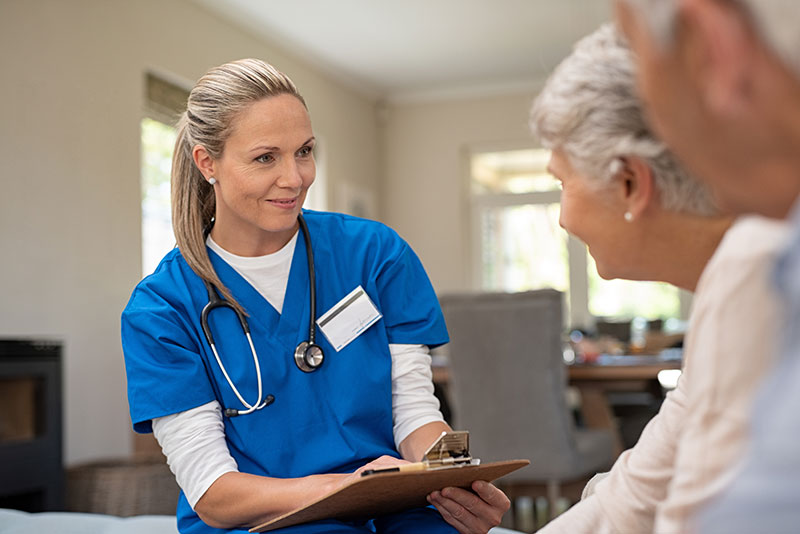 The Oaks at Bartlett | Senior couple speaking with nurse