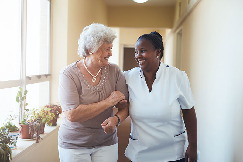 The Oaks at Bartlett | Nurse beside senior woman