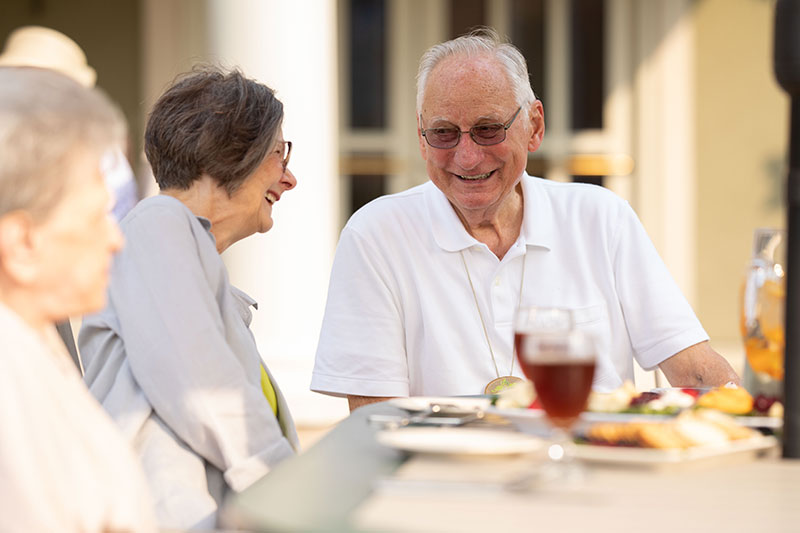 The Oaks at Bartlett | Senior man speaking with other residents