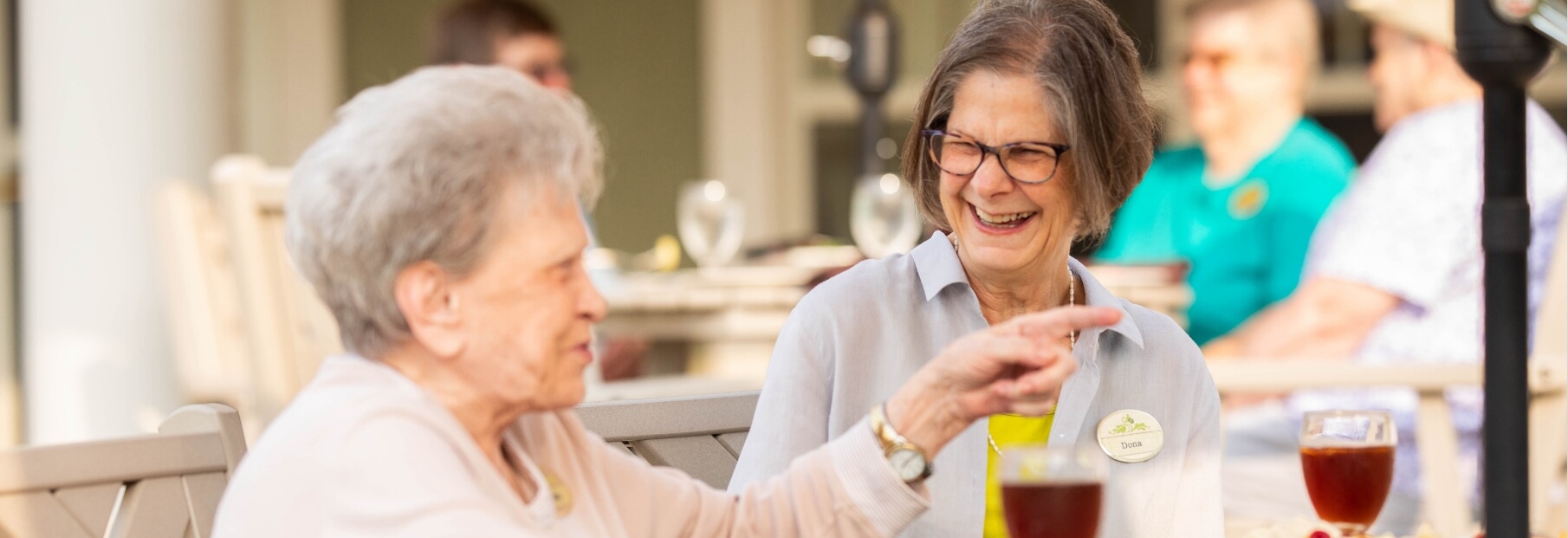 The Oaks at Bartlett | Seniors talking and laughing while having Iced tea