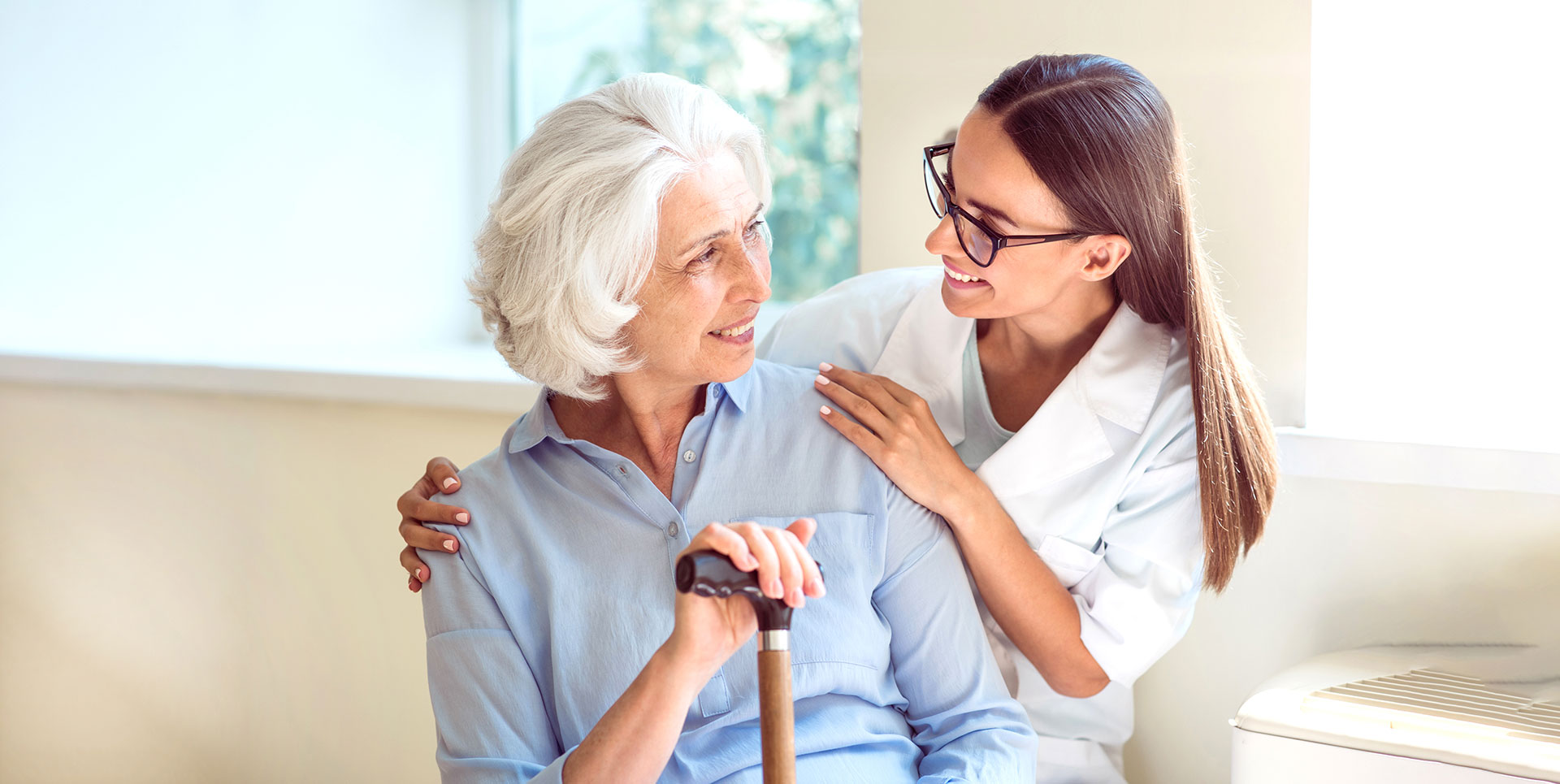 The Oaks at Bartlett | Senior and her caregiver smiling