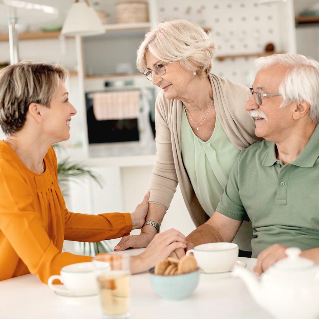 a group of older people sitting around a table.