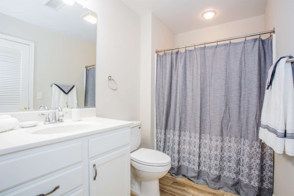 a bathroom with a shower curtain and toilet.