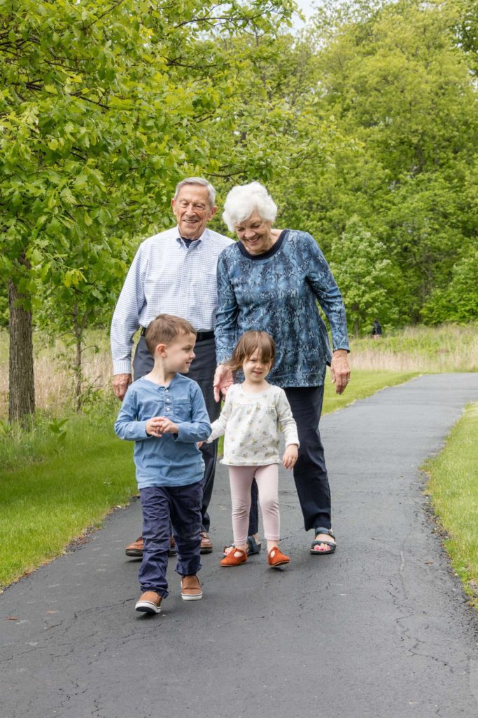 seniors on a walk with their grandchild