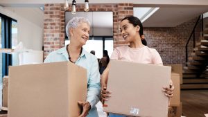 senior woman packing to move to a life plan community