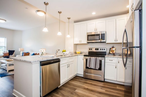 a kitchen with stainless steel appliances and hardwood floors.